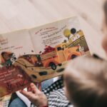 woman reading book to toddler